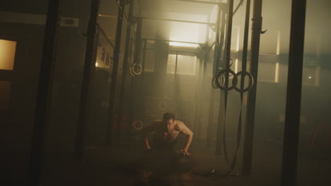man performing crossfit exercises in a gym