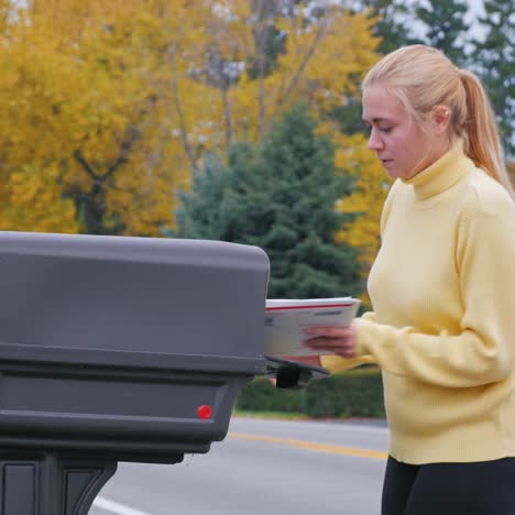 young woman takes the mail from the mailbox 1