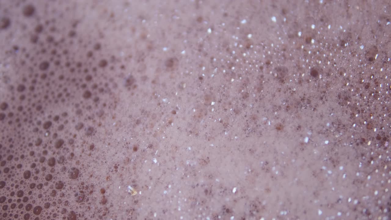 Close up shot of foam and soapy bubbles on a moving water surface, self care, bathtub
