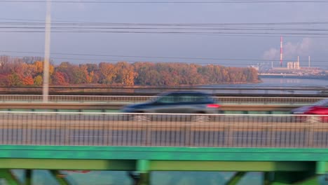 warsaw, poland. drone shot of buzzing bridge traffic, cars and vehicles moving fast on sunny autumn day
