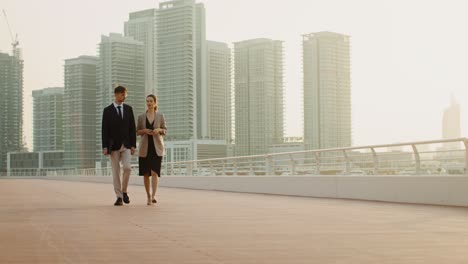business professionals discussing on a city bridge
