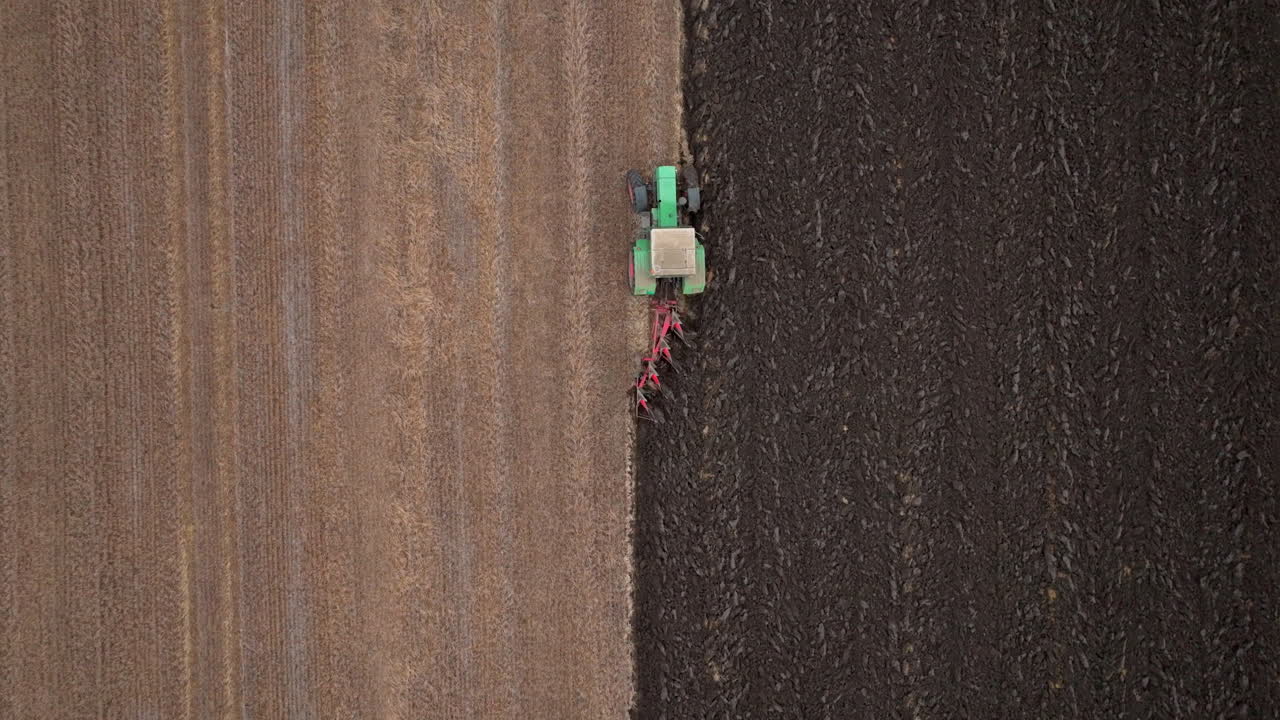 Tractor plowing field aerial view