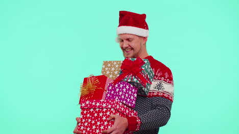 Handsome-stylish-man-in-Christmas-sweater-holding-many-gift-boxes-New-Year-presents-shopping-sale