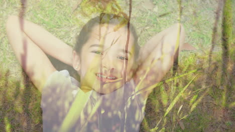 little girl lying on grass smiling