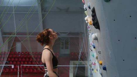 woman rock climbing on an indoor climbing wall