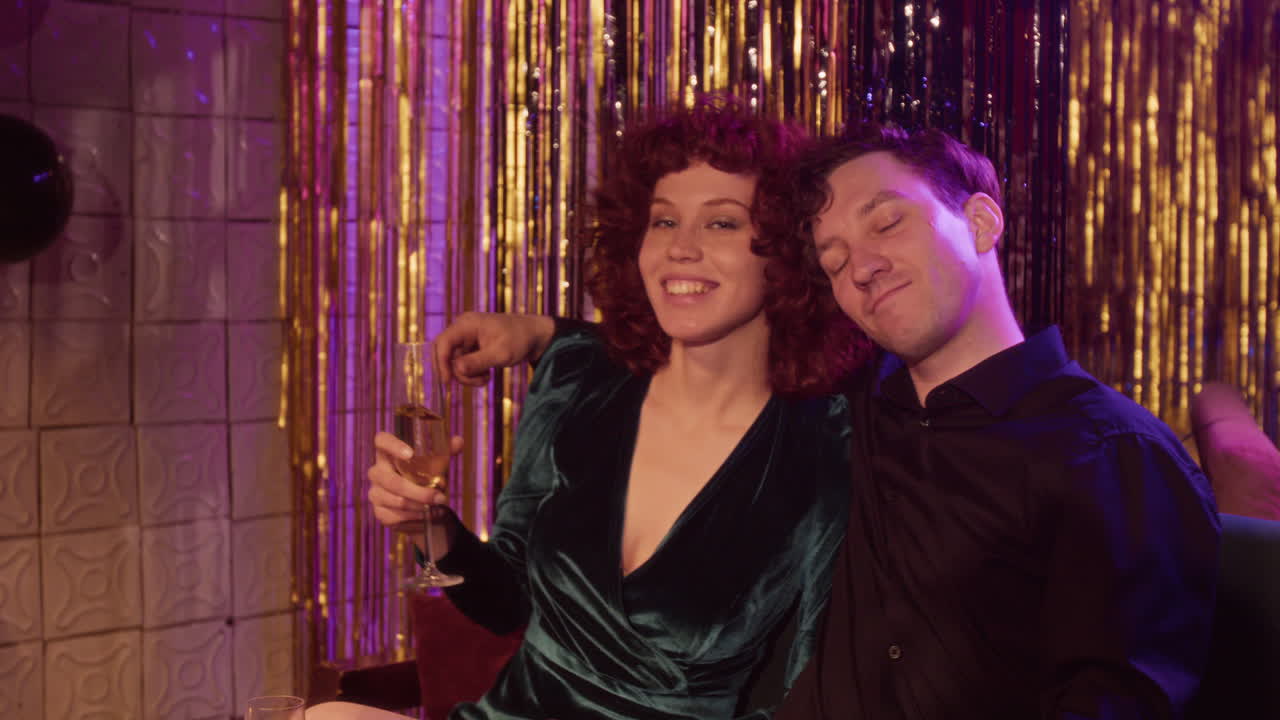 Couple celebrating with champagne at a party