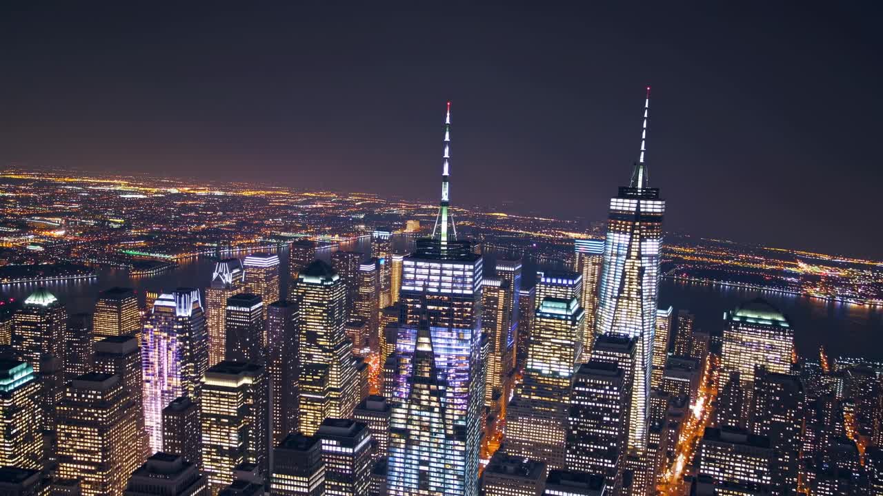 Nighttime aerial view of a vibrant city skyline showcasing illuminated skyscrapers and urban landscape, capturing the dynamic essence of city life and architectural beauty