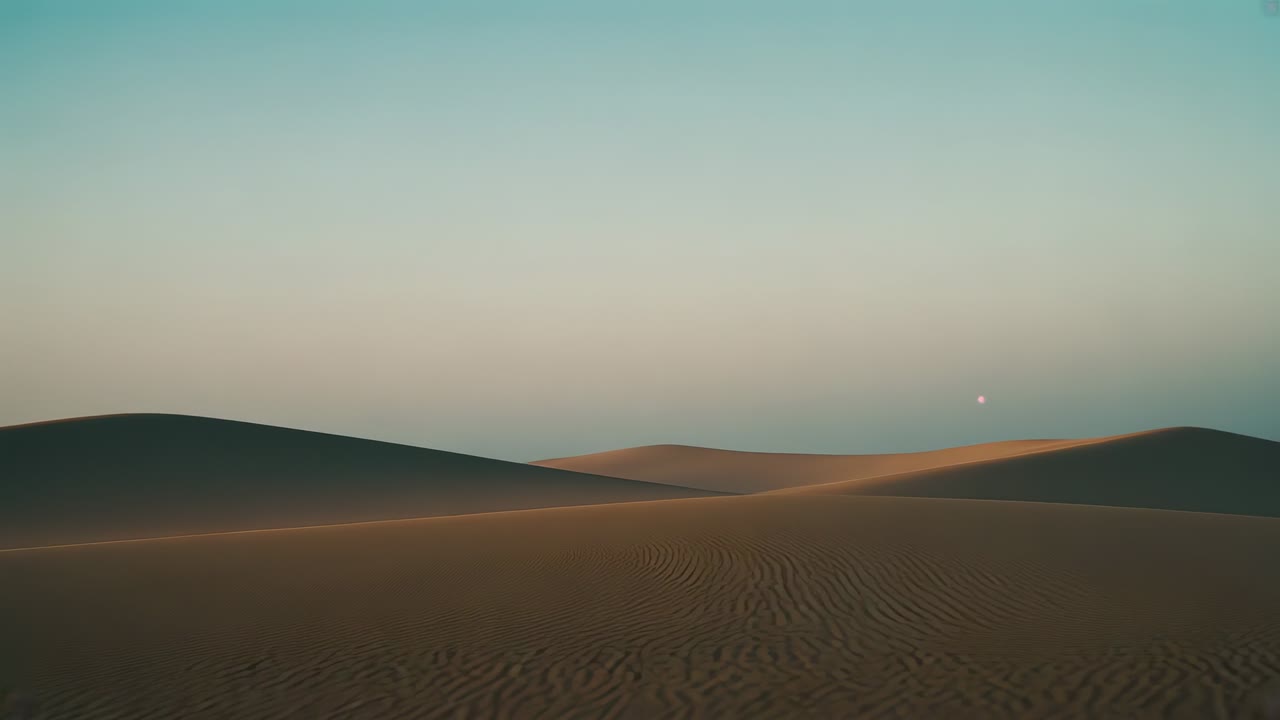 Surveying camera moving forward and panning right over desert dunes at low sun, revealing ripples