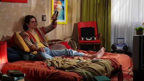 man drinking beer in retro bedroom