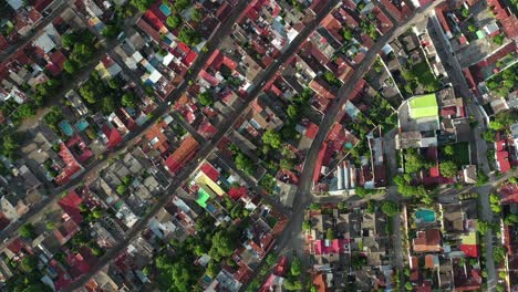 top down aerial view of honda town, tolima, colombia, colorful city buildings on golden hour sunlight, high angle drone shot