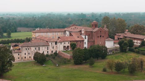 orbiting-right-close-up-movement-Abbazia-Morimondo-top-shot-in-the-countryside-of-Lombardia-close-to-Abbiategrasso