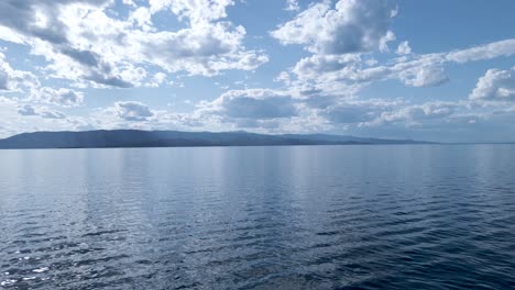 Aerial-view-of-the-tranquil-waters-of-the-Flat-Head-Lake-in-Motana-with-stratus-clouds