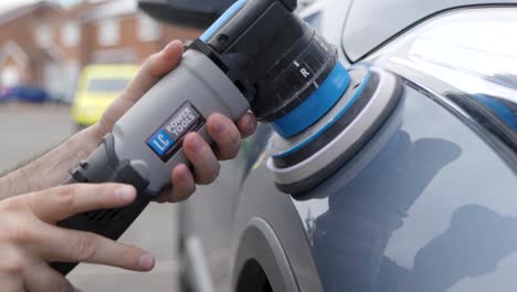 polishing car fender with machine