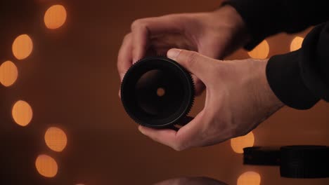 hand model opens and closes aperture on a cine lens