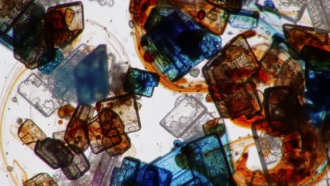 a stunning macro view of colorful crystals and microscopic structures captured in two frames of a video, showcasing unique patterns and intricate details