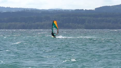 windsurfer going fast on a swiss lake