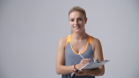 Slow-Motion-Sequence-Of-Female-Sports-Coach-With-Clipboard