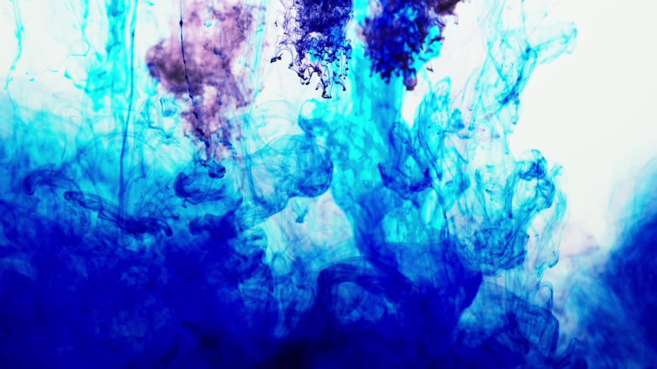 Purple And Blue Paint Or Dye Dropped Into Water Against White Background To Create Swirling Colourful Smoke Background 7