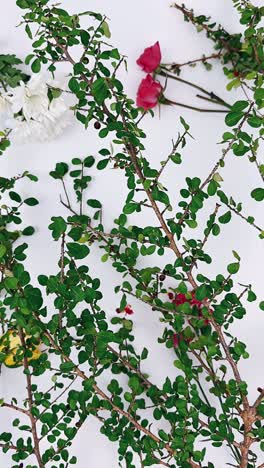 floral arrangement with roses and branches