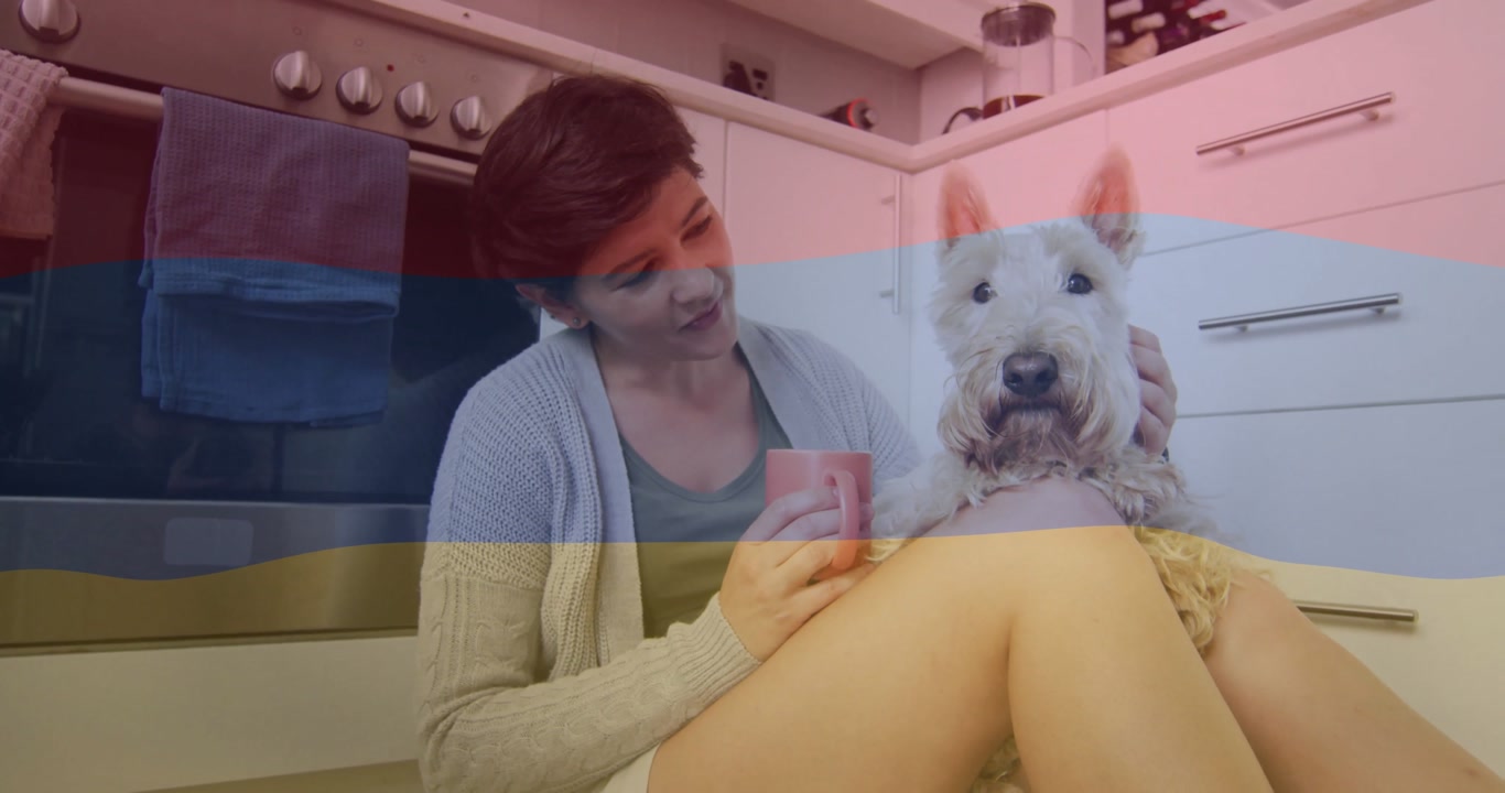Woman carrying mug settling in kitchen sipping and petting terrier dog creating pet care moment