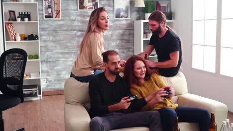 Bearded-man-with-long-hair-eating-chips-in-living-room