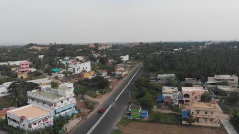 Beautiful-Landscape-Of-Highway,-Buildings,-And-Forest-with-driving-cars-and-bike-on-highway-road-in-India