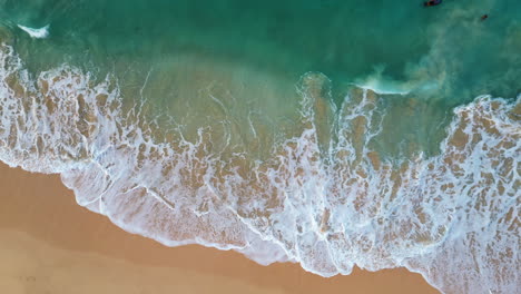 Drone-headshot-of-waves-at-sandy-beach-Oahu,-Hawaii