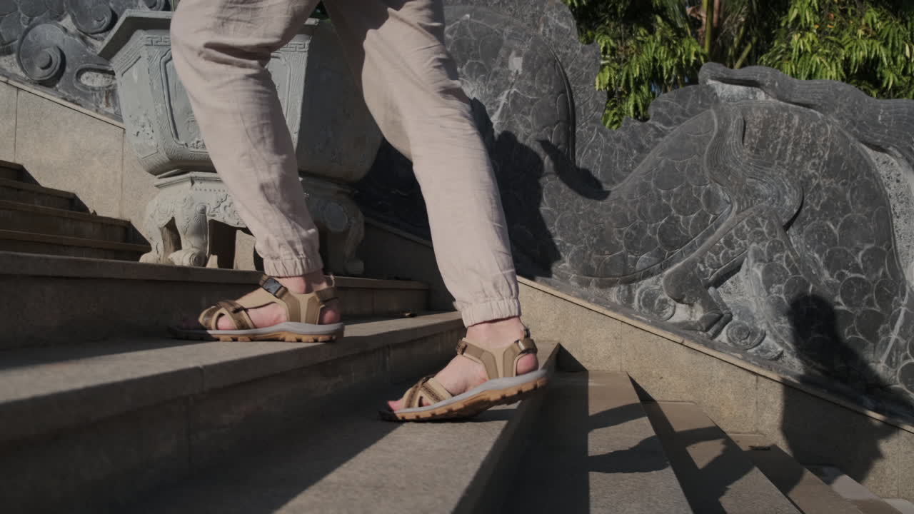Person walking up stairs in a temple