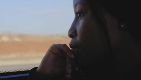 a close up of female traveller  looking through window