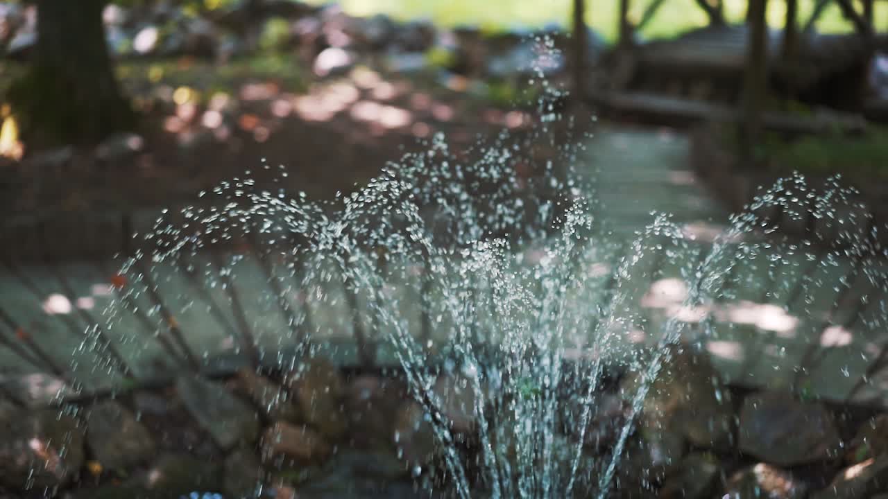 Water fountain. Fountain in the garden. Water drops