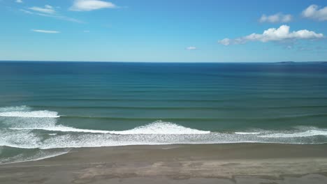 Sandy beach and waves on a sunny calm day