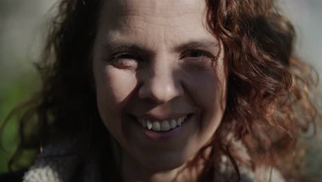 close up shot of smiling mature woman looking at camera