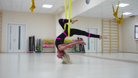 Star-Inversion-aerial-antigravity-yoga-pose,-woman-exerciseses-with-hammock