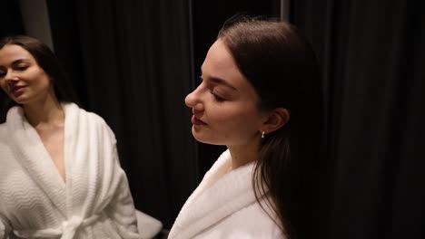 Young-woman-getting-ready-for-bed-while-putting-on-a-hair-scrunchie-and-sleep-mask