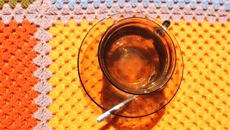 tea cup on a colorful crochet doily