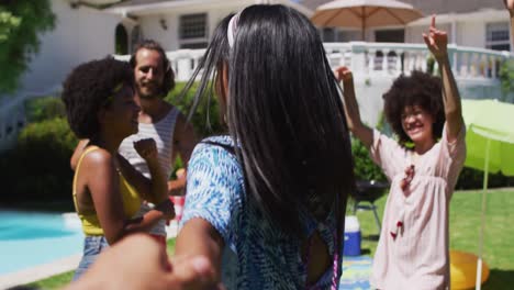 diverse group of friends having fun and dancing at a pool party