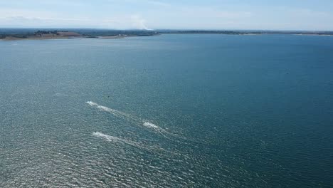 Drone-high-above-a-lake-with-speed-boats