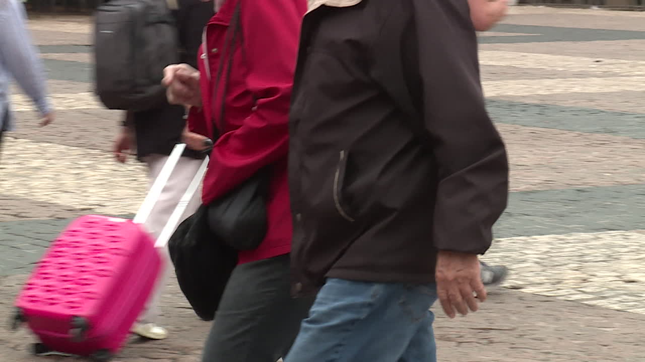 Older couple walking in city street