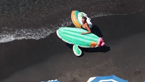 woman with inflatable enjoying beach in sorrento, italy