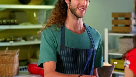 male staff discussing over food items with customer at the counter