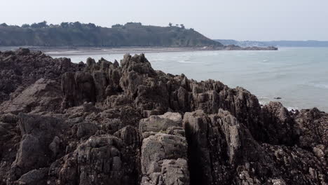 the rocky shore of brittany's coastline at martin plage aerial reveal