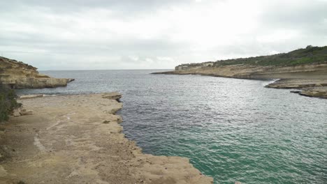 wide view of il-kalanka beach in malta on cloudy rainy winter day in malta