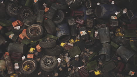 discarded tires and containers in a daytime urban recycling area