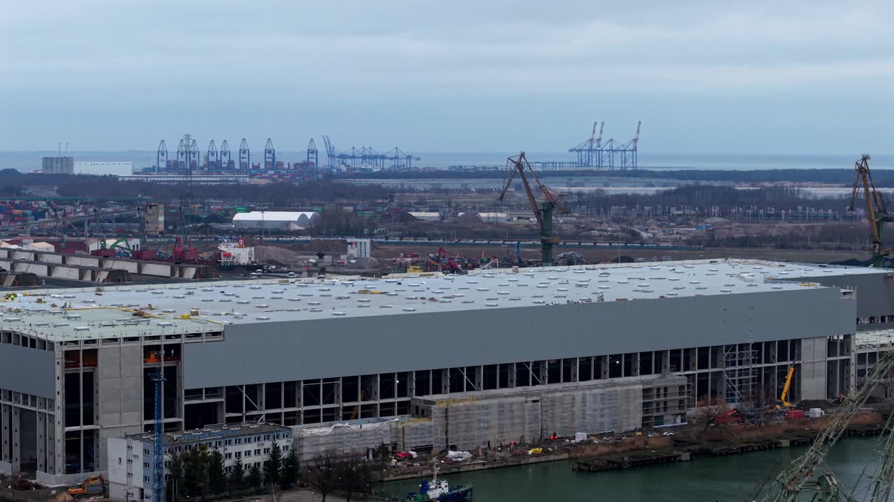 Drone aerial establishing of Gdansk Shipyard with Baltic Hub Container Terminal and warehouses, cranes on horizon