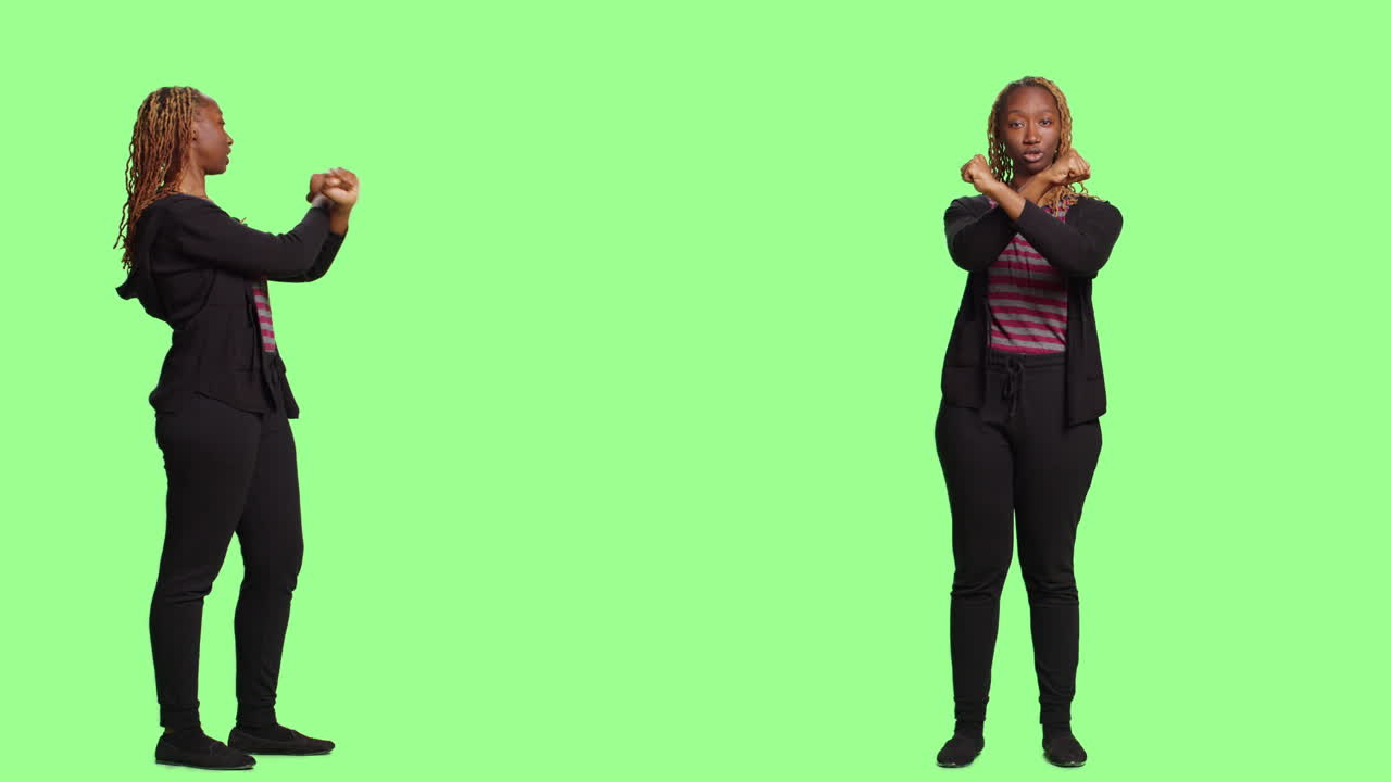 Woman crossing arms on green background