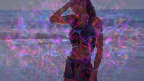 on beach, silhouette of person with colorful animation overlay pattern
