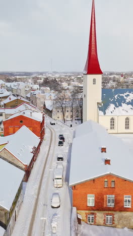 vertical aerial of snowy streets and the church, winter day in rakvere, estonia