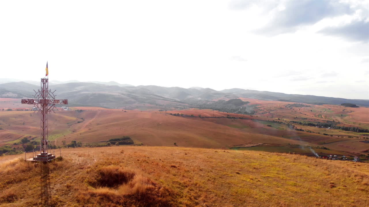 Large Cross with Romania flag on High Hill and landscape at Summer