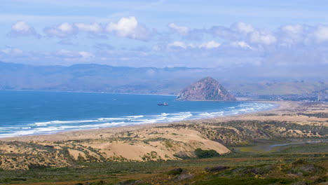 ocean view looking over moro bay, california with sea waves and boat