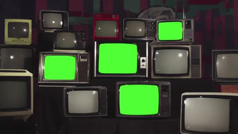 four retro stacked televisions turning on green screen. zoom out. 4k resolution.